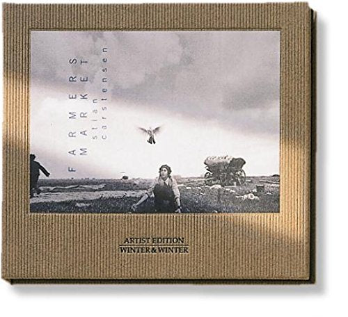 CD case with a black and white landscape and bird image.