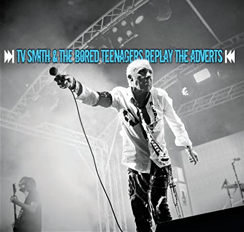 Live performance photo of a singer with a microphone on stage.