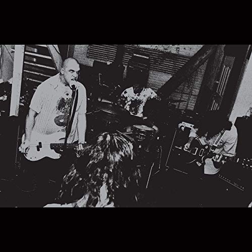 Black and white photo of a band performing, vinyl record cover.