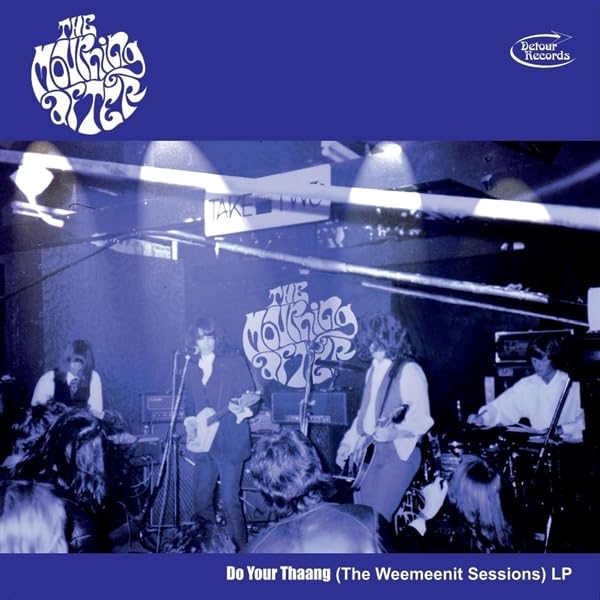 Vinyl record cover: band performing on stage, blue and white lettering.
