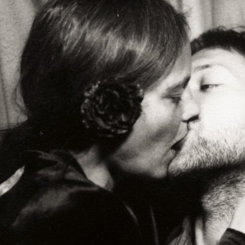 Black and white photo of a couple kissing closely.