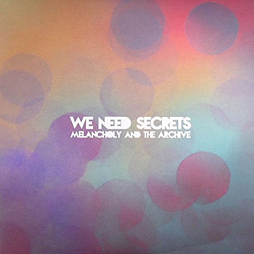 Album cover with colorful blurred circles and white text: "We Need Secrets".