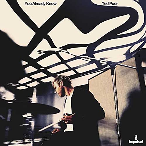 CD cover featuring a man playing drums against a black and white abstract background.