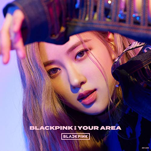 Rosé of Blackpink gazes at the viewer, wearing a black hat and pink hair.