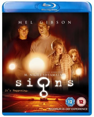 Signs" Blu-ray cover featuring Mel Gibson, Joaquin Phoenix, and a crop circle.