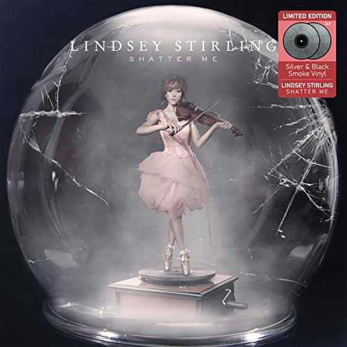 Lindsey Stirling playing violin inside a cracked glass dome.