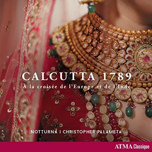 Close-up of ornate Indian jewelry and red fabric, CD cover art.