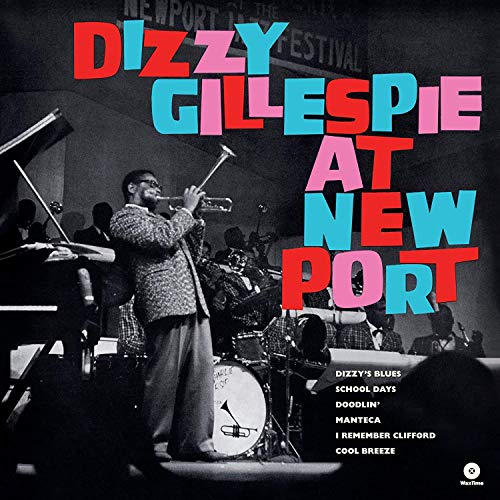Black and white photo of Dizzy Gillespie playing trumpet with his jazz band onstage.