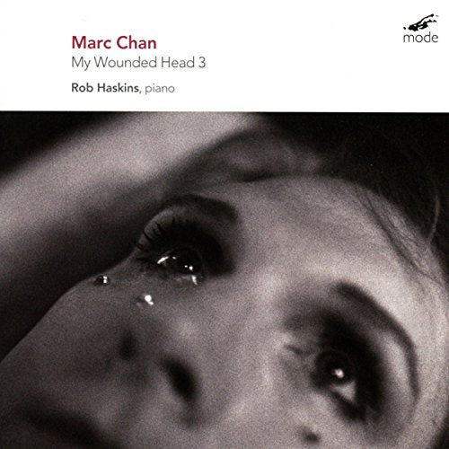 CD cover: Close-up of a face with a tear falling from the eye.