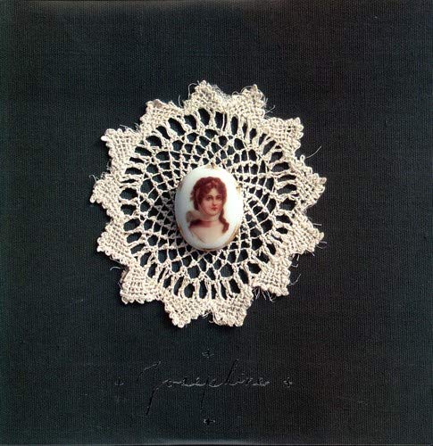 Black album cover with a cameo portrait framed by white lace.