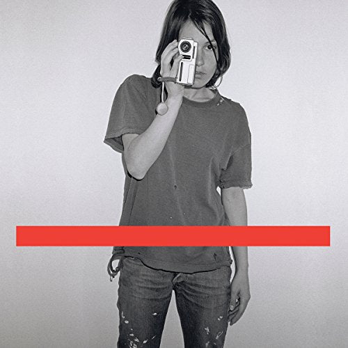 Black and white portrait of a person holding a camera, with a red stripe.