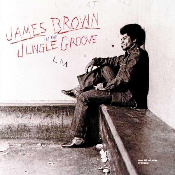 James Brown seated against a wall with graffiti, album cover art.