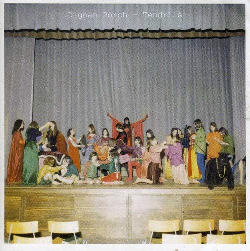 CD cover: group in robes on a stage with blue curtains.