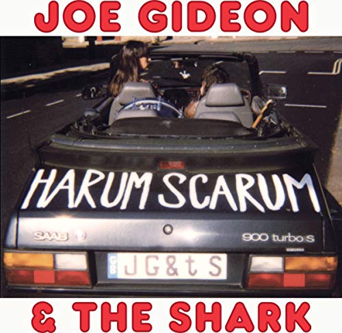 Album cover: two people in a Saab 900 turbo, red text overlay.