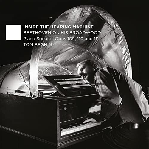 Pianist Tom Beghin at a Broadwood piano, covered by a translucent arch.