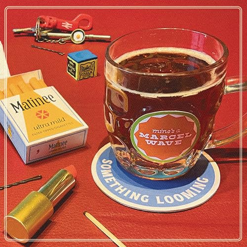 Vinyl record cover with cigarettes, a glass of tea, and chalk.