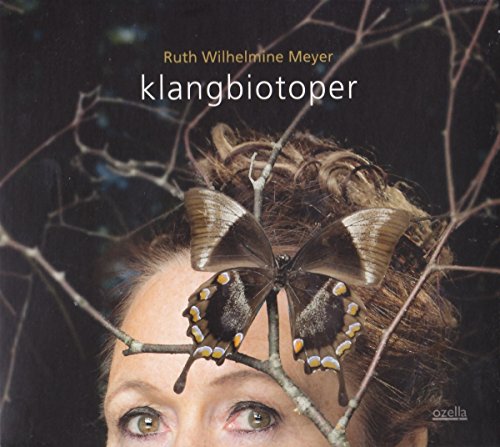 CD cover with a woman’s face, butterfly, and bare branches.
