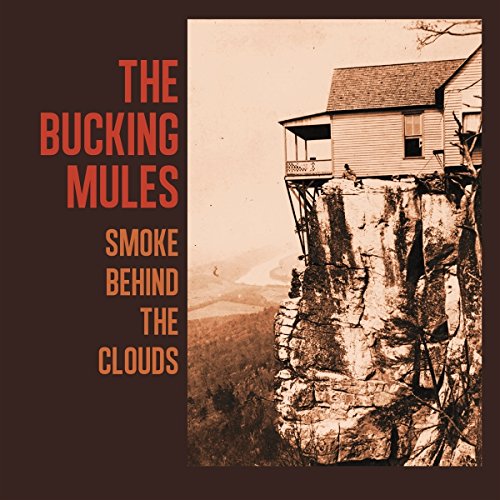 CD cover for The Bucking Mules’ “Smoke Behind The Clouds” with a cliffside house.