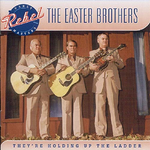 CD cover featuring three men in suits playing acoustic guitars.
