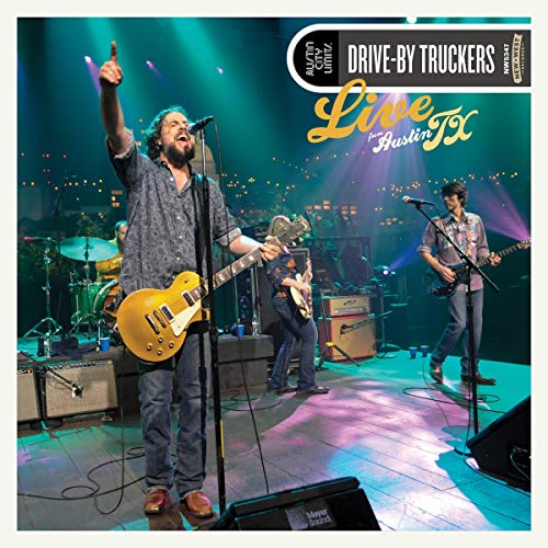 Drive-By Truckers band performing live on stage with instruments and lights.