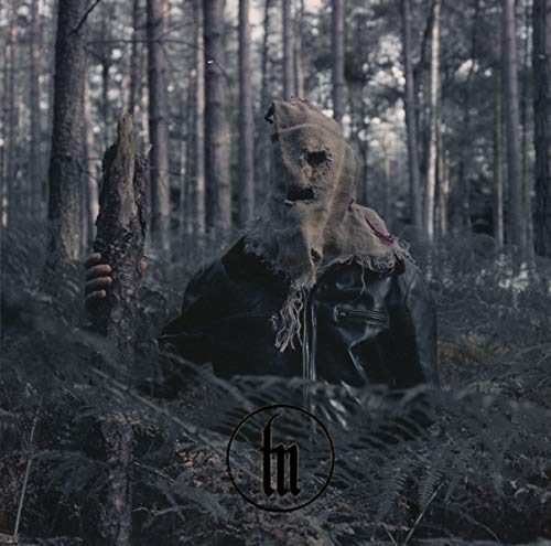 Figure in a burlap sack stands in a dark, dense forest.