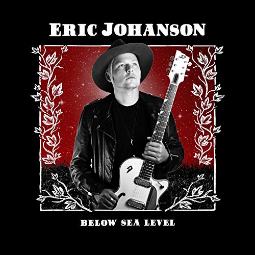 Eric Johanson holding a guitar, album cover with red and black design.