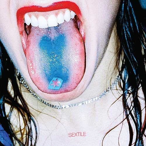 Close-up of open mouth with blue tongue and silver necklace.