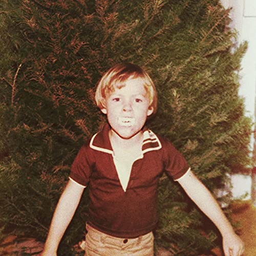 CD cover featuring a young boy with short hair in front of a tree.