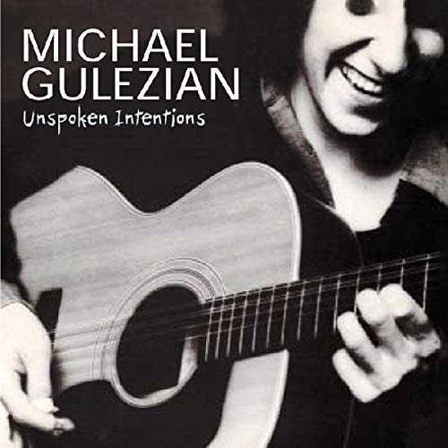 CD cover: Man with acoustic guitar, black and white portrait.