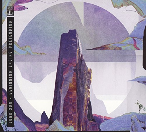 CD cover with a purple, rocky spire against a hazy landscape.