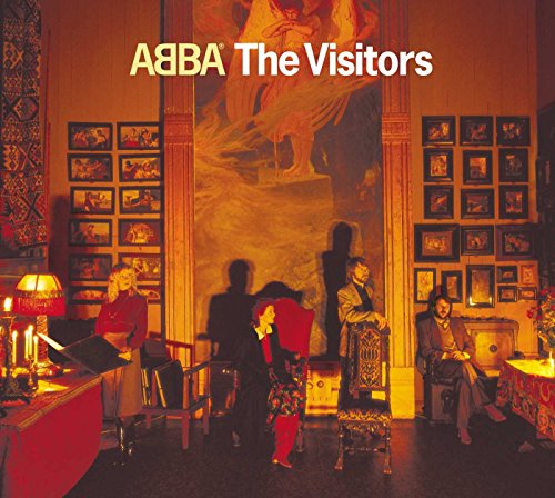 The four members of ABBA sit in a dimly lit, art-filled room.