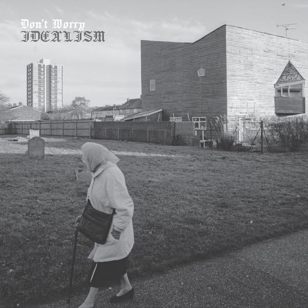 Black and white album cover featuring a woman walking by buildings.