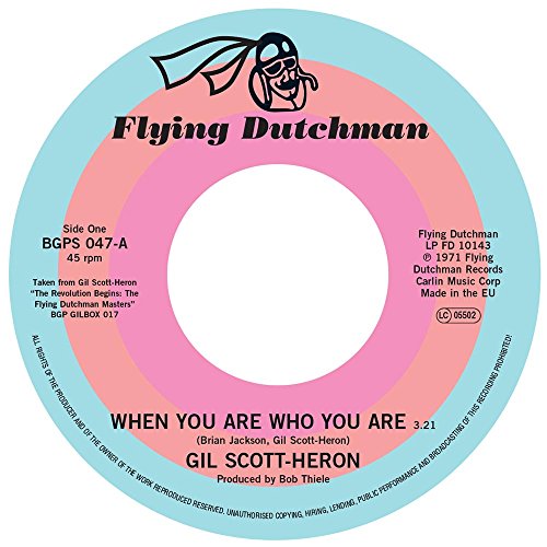 Vinyl record label with blue, pink, and white concentric circles; text details.