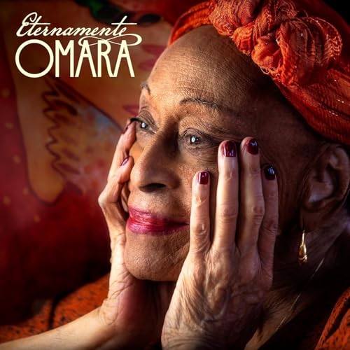 Close-up portrait of Omara Portuondo with a red headwrap, looking thoughtfully.
