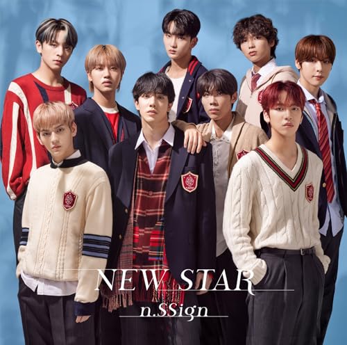 Nine young men in school uniform-style clothing pose for a group portrait.