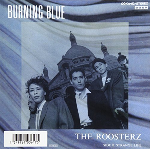 Vinyl record cover featuring four men in suits with a building backdrop.