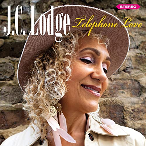 J.C. Lodge album cover featuring a woman in a hat and brick background.
