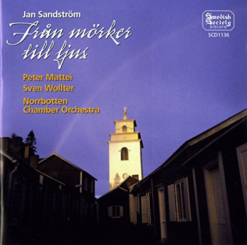 CD cover with a church tower illuminated against a dark blue sky.
