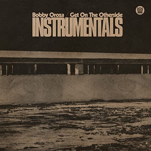 Bobby Oroza album cover with a concrete wall and dark asphalt road.