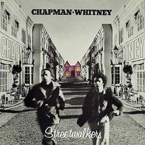 Album cover: two figures in coats stand on a street with buildings.