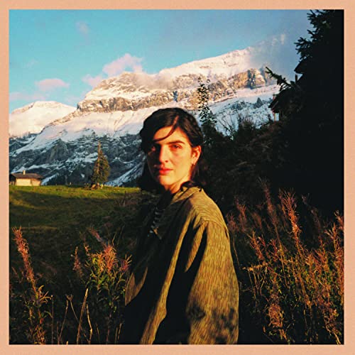 Portrait of a person with mountains in the background, album cover.