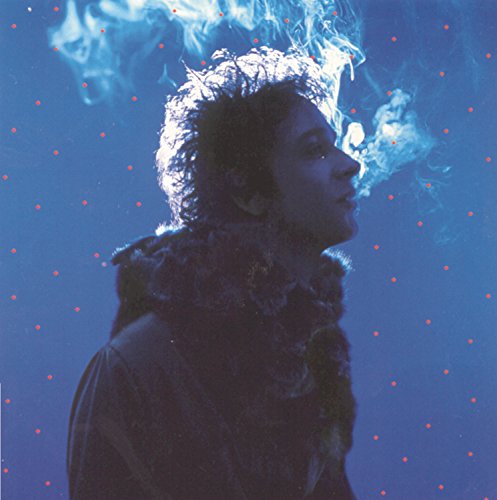 CD cover: man exhaling smoke against a blue, speckled background.