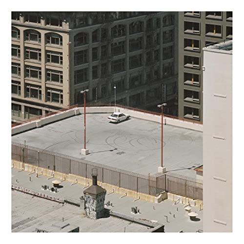 Album cover for Arctic Monkeys’ “The Car” showing a car on a rooftop.