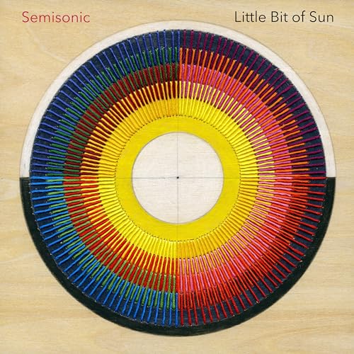 Album cover featuring a circular rainbow thread design on a light wood background.