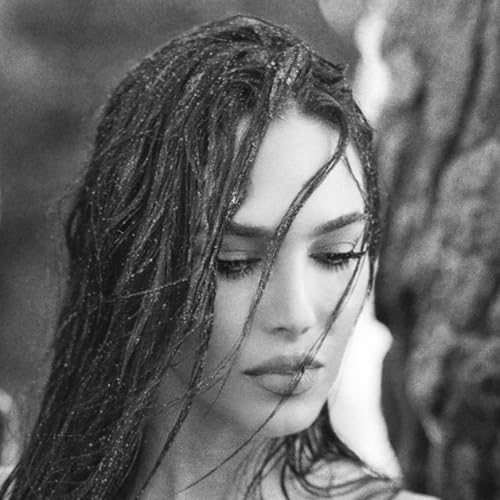Black and white portrait of a woman with wet hair, looking down.