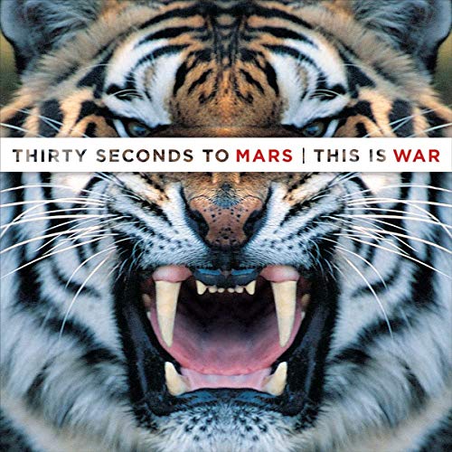 Close-up of a roaring tiger's face with album title text across the center.