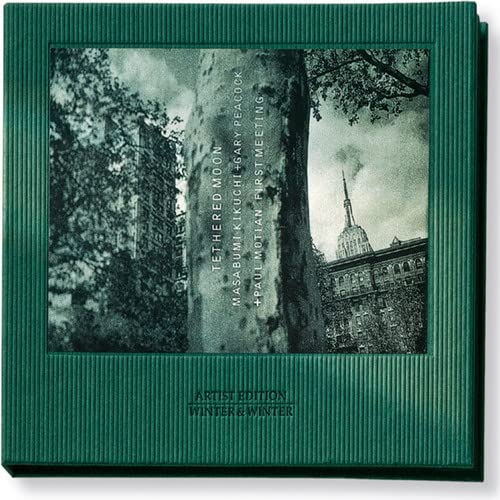 CD case with a grayscale image of a tree and distant cityscape.