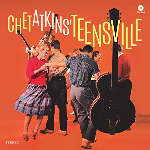 Black vinyl record in a sleeve with colorful graphics and multiple artist names listed.