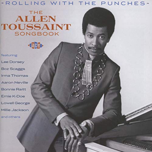 Album cover featuring Allen Toussaint in a suit and necklace leaning on a piano.