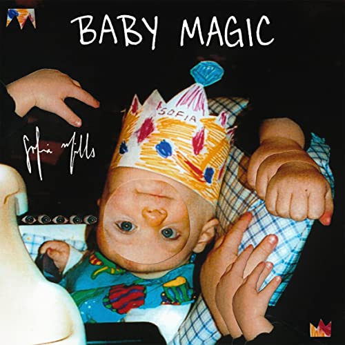 Upside-down photo of a baby wearing a paper crown, with text reading Baby Magic.